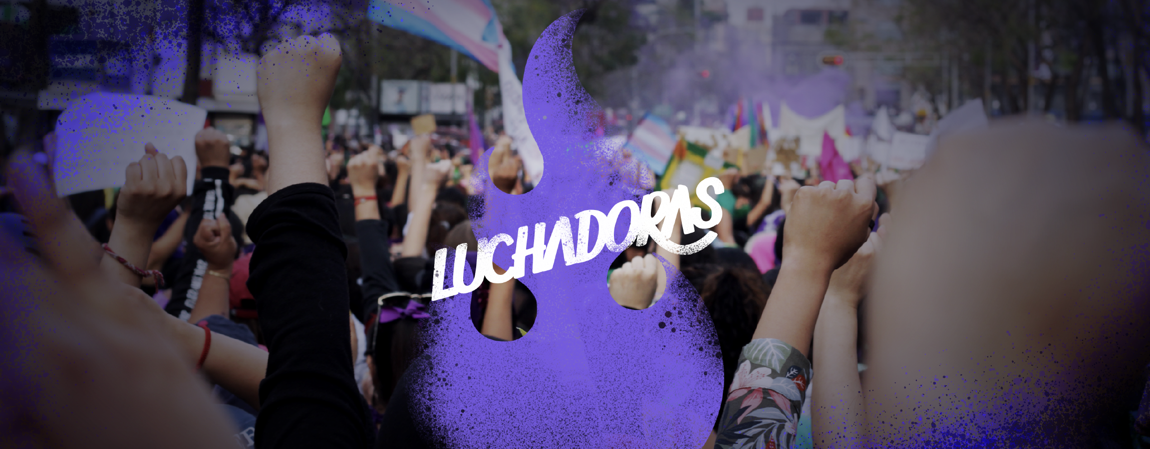 Luchadoras logo in white over a purple flame with a graffiti texture, superimposed on a photograph of numerous raised fists at a demonstration, with trans community flags.