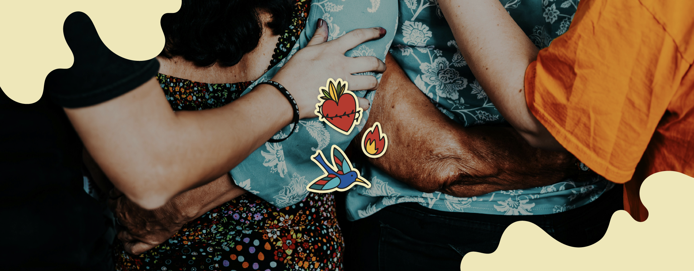 Graphic elements from the Fe y Democracia visual identity applied to a photograph of people of different ages and skin tones embracing. The elements consist of three illustrations: a blue bird, a heart and a flame.